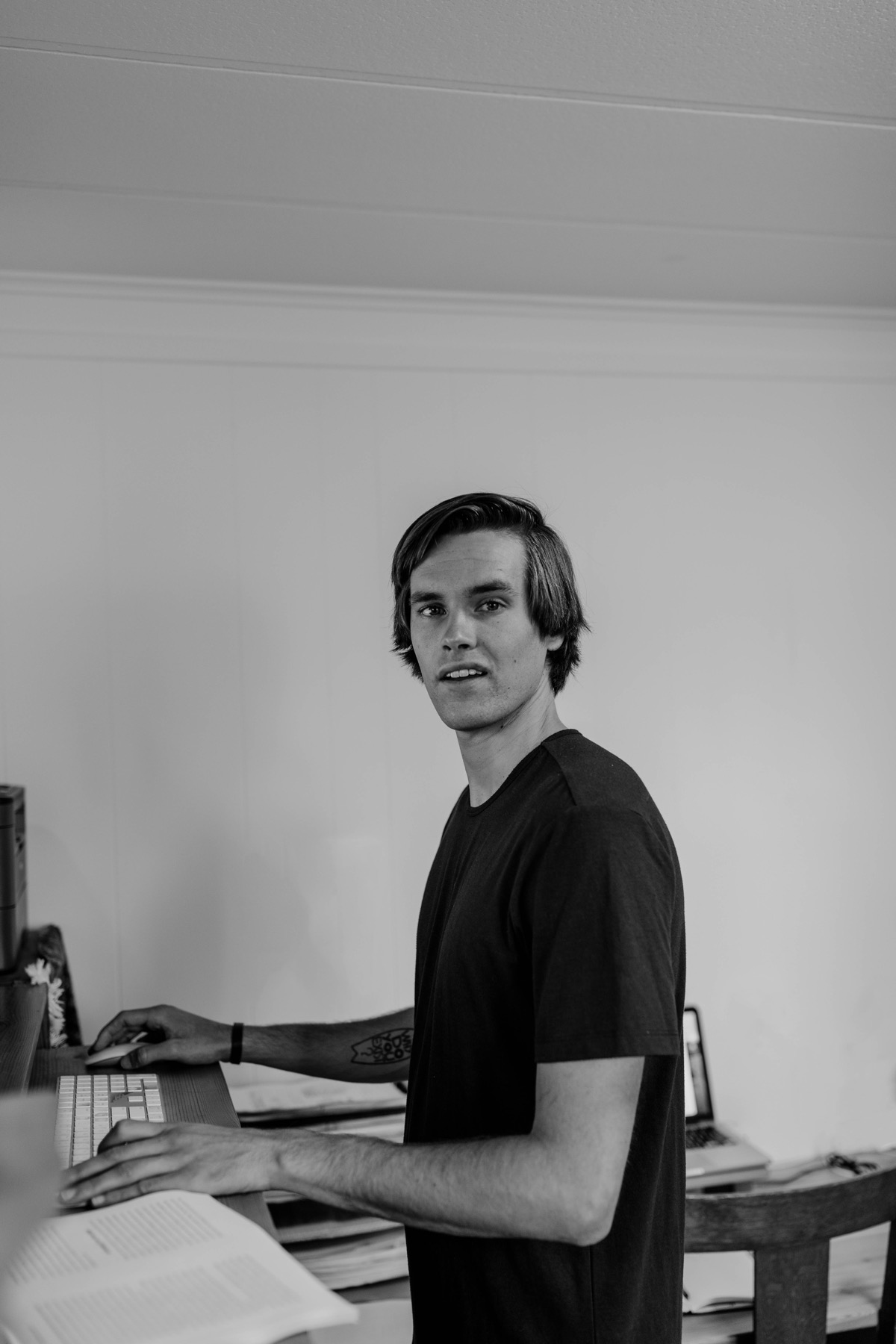 Black-and-white photo of Kory Kirby at his desk